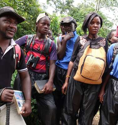 Fünf Menschen stehen im Wald.