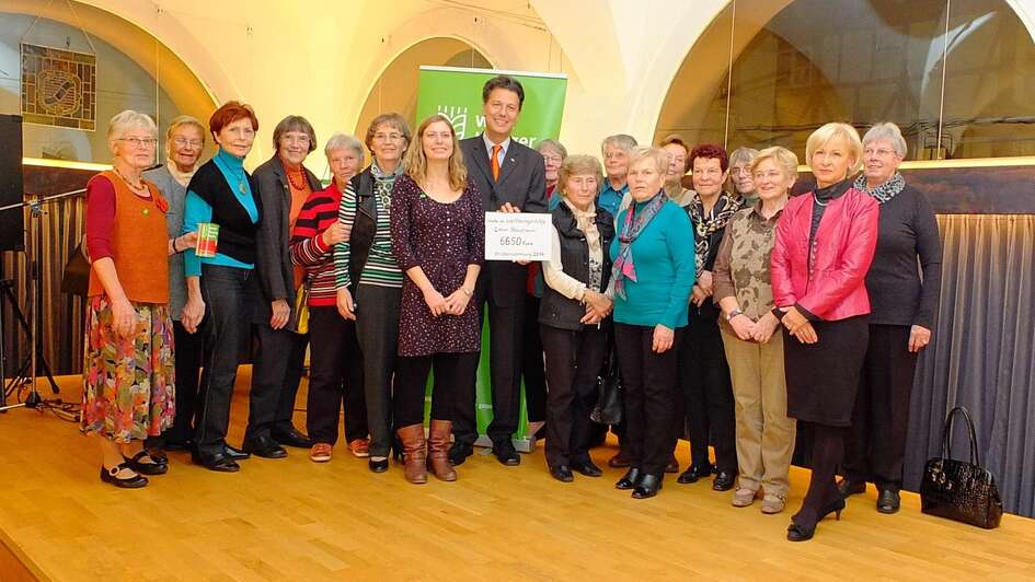 Lohrer Hausfrauen und Michael Hofmann bei einer Spendenscheckübergabe
