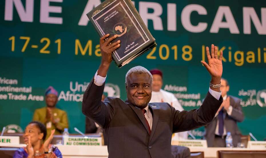 Moussa Faki Mahamat hält eine Mappe hoch und feiert die Unterzeichnung des Freihandelsabkommens durch die Staats- und Regierungschefs, Kigali, 2018.