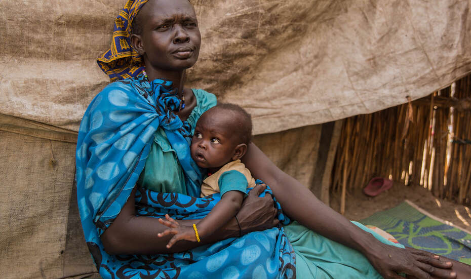 Jetzt spenden für Menschen im Südsudan. Bildbeschreibung: Eine Frau mit ihrem Kleinkind in Ganyiel, Südsudan.