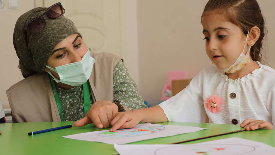 Eine Frau und ein Kind sitzen nebeneinander.