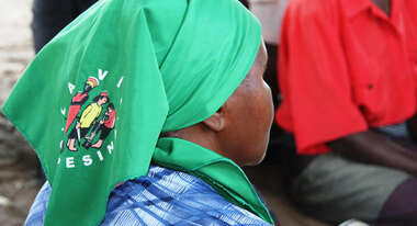Eine Frau in Bolivien mit grünem La Via Campesina Tuch. 