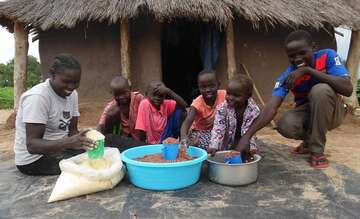 Hellen und ihre Kinder sortieren Waren für den Verkauf auf dem Abendmarkt.