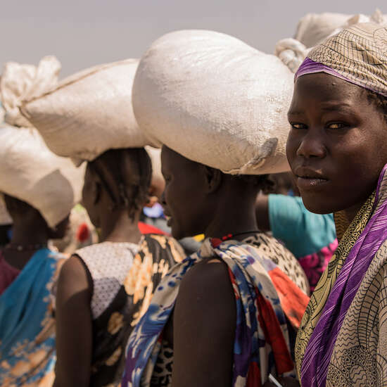 Hungersnöte verhindern. Bild: Frauen bei einer Lebensmittelverteilung im Flüchtlingscamp Bentiu.